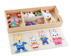 Detail showing wooden rabbit dress-up puzzle set with organized storage compartments