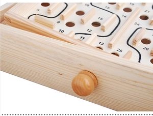 Detail of wooden ball maze game showing the numbered path and smooth timber surface