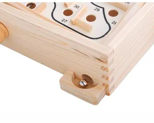 Macro detail of wooden marble maze toy with steel ball and numbered paths for coordination
