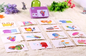 Detail of educational matching puzzle cards and purple metal box on white carpet
