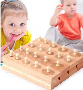 Detail of Montessori wooden cylinder socket blocks showing natural beech wood texture