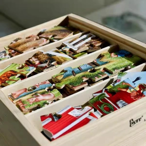 24-piece wooden puzzle set with farm animal patterns in a divided wooden storage box