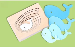 Detail of layered blue whale wooden puzzle showing color gradient on wood base