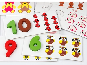 Close-up of wooden numbers and animal cards for children's counting and puzzle pairing