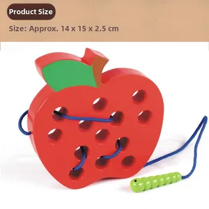 Detail showing red wooden apple lacing toy with a green caterpillar threader and blue cord
