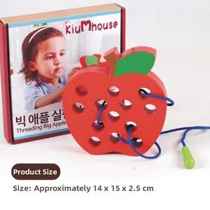 Detail of wooden apple lacing toy with red finish and blue threading cord in packaging