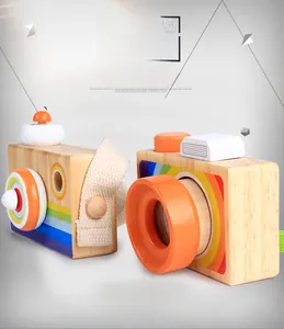 Close-up of wooden cartoon camera toys with rainbow stripes and orange lens detail