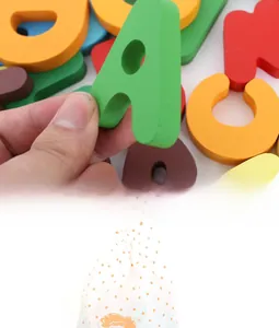 Detailed close-up of colorful wooden alphabet blocks with a matching lion drawstring storage bag