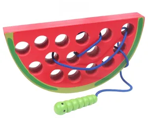 Macro detail of wooden threading toy showing watermelon texture and 13 lacing holes