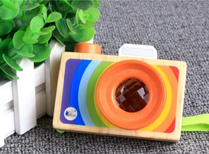 Close-up of wooden toy camera with rainbow colors and multi-prism kaleidoscope lens