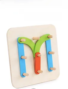 Macro shot of colorful wooden strips forming letter M on a pegboard educational toy