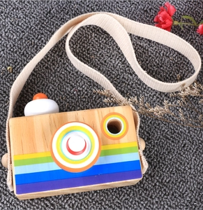Close-up of a wooden toy camera with rainbow stripes and a comfortable cotton neck strap