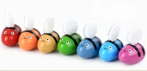 Set of seven colorful wooden bees in rainbow colors for fine motor skill development