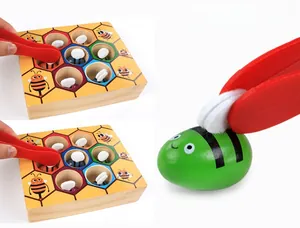 Macro shot of colorful wooden bees and tweezers for Montessori fine motor skill training