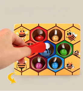 Close-up of tweezers picking a wooden bee to show fine motor skill training