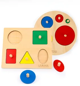 Detail of wooden Montessori geometric shape puzzles with red and yellow knobs on white background
