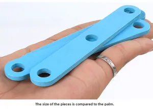 Blue wooden block with round hole for size comparison against hand in detail view
