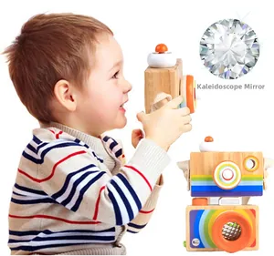 Detail view of the rainbow-striped wooden camera toy with kaleidoscope lens prism effect