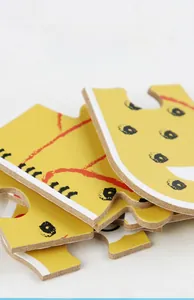 Close-up of thick wooden puzzle pieces showing smooth edges and vivid animal patterns