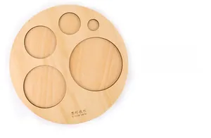 Detail view of Montessori wooden circular panel with four size-graduated round puzzle pieces