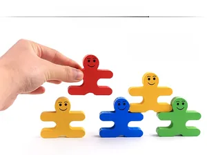 Close-up of colorful wooden balance building blocks being stacked by hand for kids
