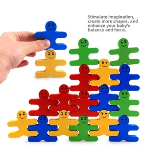 Close-up of hand balancing colorful wooden human-shaped stacking blocks for kids