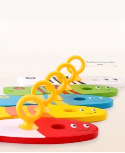 Close-up of numbered colorful wooden fish toys with plastic rings for educational fishing game