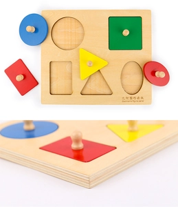 Detail of wooden Montessori puzzle showing thickness of shapes and easy-grip knobs