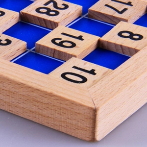 Montessori 1-100 number board featuring wooden tiles on a blue grid puzzle base