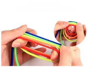 Close-up of hands stretching highly elastic colorful bands to show durability