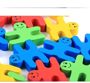 Close-up of wooden balance blocks with colorful human shapes and smooth smiley faces
