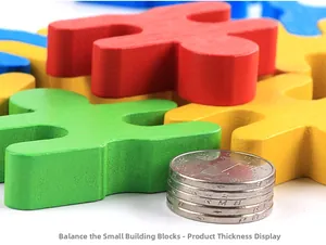 Detail showing thickness of colorful wooden balance block compared to stacked coins
