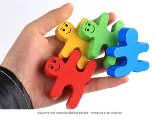 Hand holding colorful wooden balancing blocks showing compact size for early education