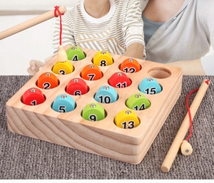 Close-up of colorful numbered wooden magnetic fish and rods for children learning