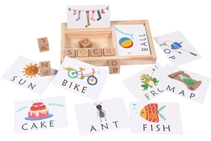 Close-up of wooden alphabet blocks with colorful word cards for spelling learning