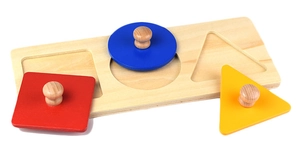 Detail of wooden Montessori puzzle with colorful shapes and easy-grip round knobs