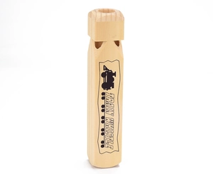 Macro shot of natural wood train whistle with black printed text and engine graphics