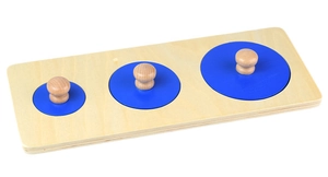 Macro detail of wooden Montessori puzzle featuring three blue circles with knobs on a base