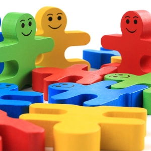 Colorful wooden balancing blocks with smiling faces for creative educational play