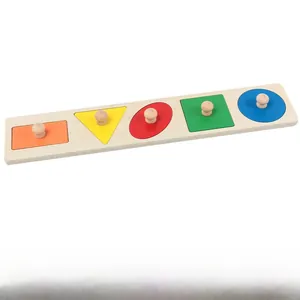Close-up of wooden Montessori board with five colorful geometric shapes and handles