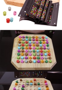 Detailed macro view of wooden Sudoku board game with colorful numbered pieces and instruction book