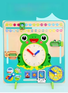Macro view of wooden educational clock board with frog design and calendar sliders
