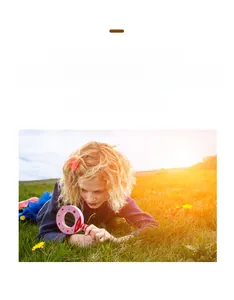 Educational wooden magnifying glass with pink frame for children exploring nature outdoors