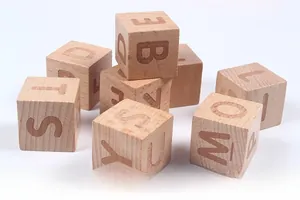 Macro detail of natural wood letter blocks featuring engraved uppercase English alphabets