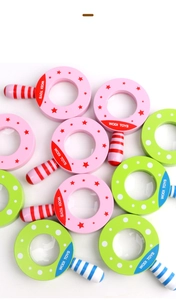 Detailed view of colorful wooden magnifying glass toys with star and polka dot patterns