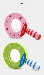 Detail view of two colorful wooden magnifying glass toys for children with star and dot patterns