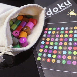 Wooden Sudoku board game set for kids with colorful numbered pieces and drawstring bag