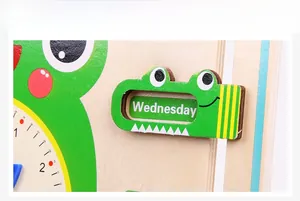 Detail of wooden calendar clock showing weekday sliders and clock dial for kids