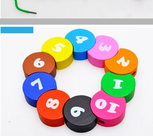 Macro view of wooden rainbow number beads with threading string for counting and motor skills