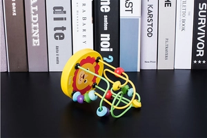 Macro view of lion theme bead maze toy with yellow base and colorful wooden beads